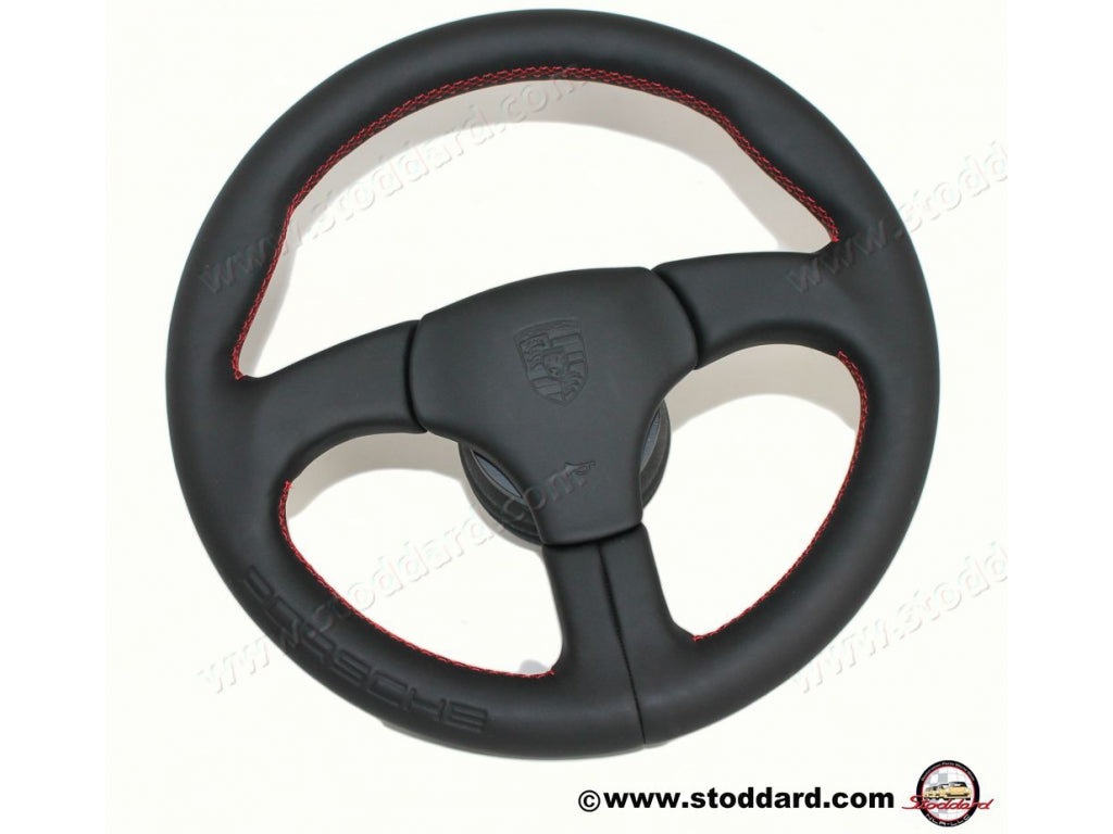 Factory Sports Steering Wheel with Red Stitching and Embossed Porsche Logo.