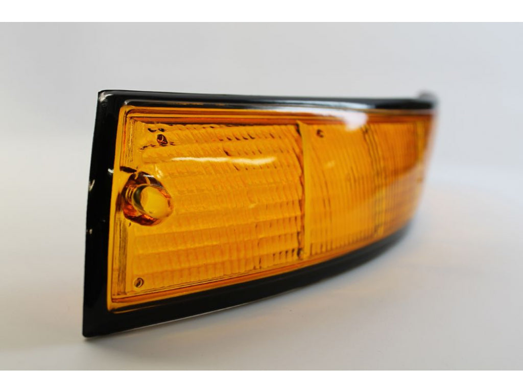 USA-spec Front Turn Signal Lens, Left with Black Trim.